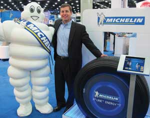 michelin mascot bibendum and ted becker, vice president of marketing for michelin americas truck tires, show off the new x line energy t. 