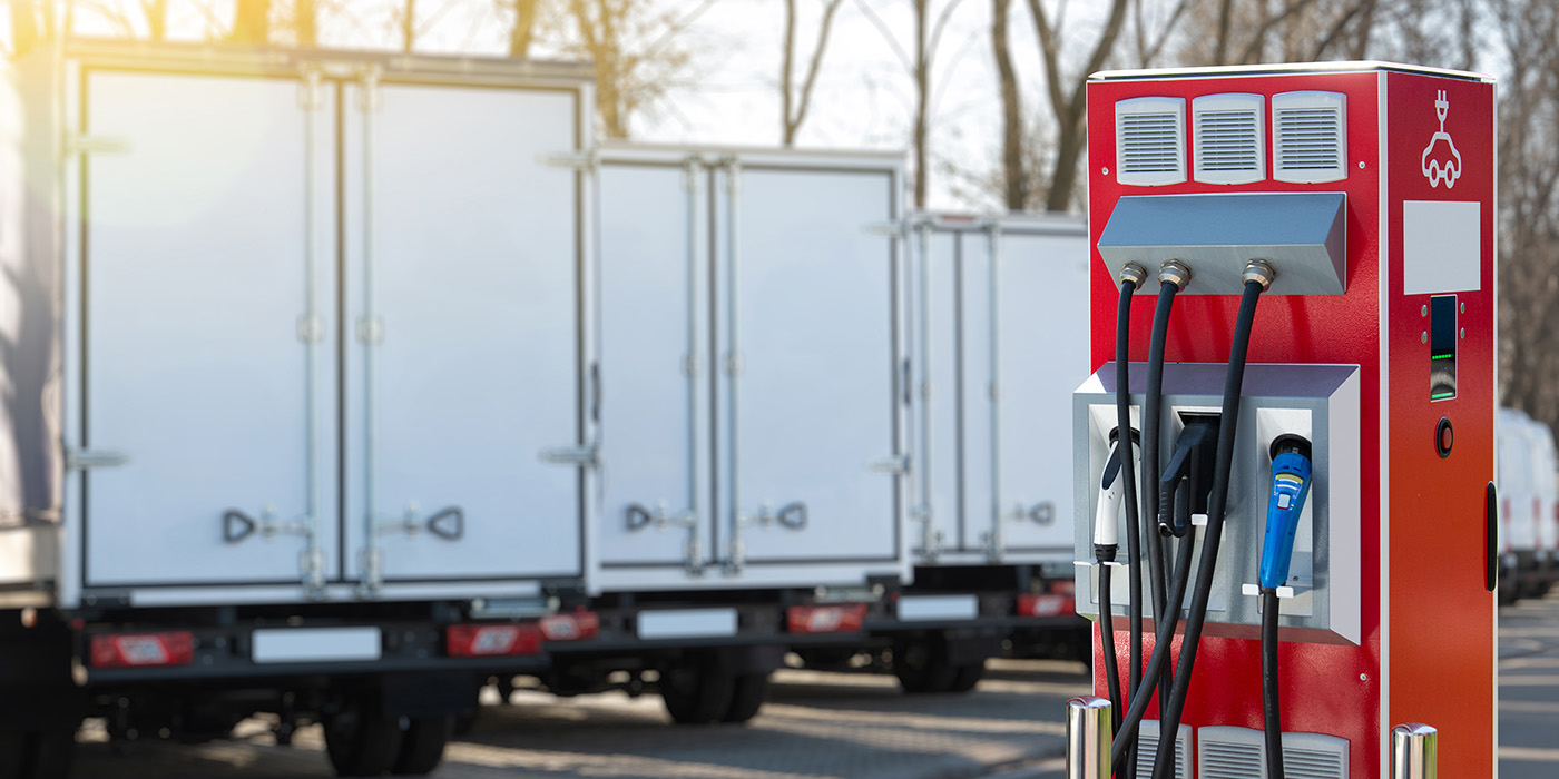 electric-ev-trucks-fleet-charging outside-infrastructure-generic