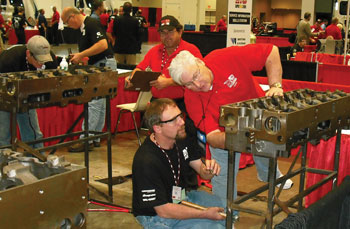 Judge, Lew Flowers (right), words with contestant Tim Zieman on the fastener skill station.